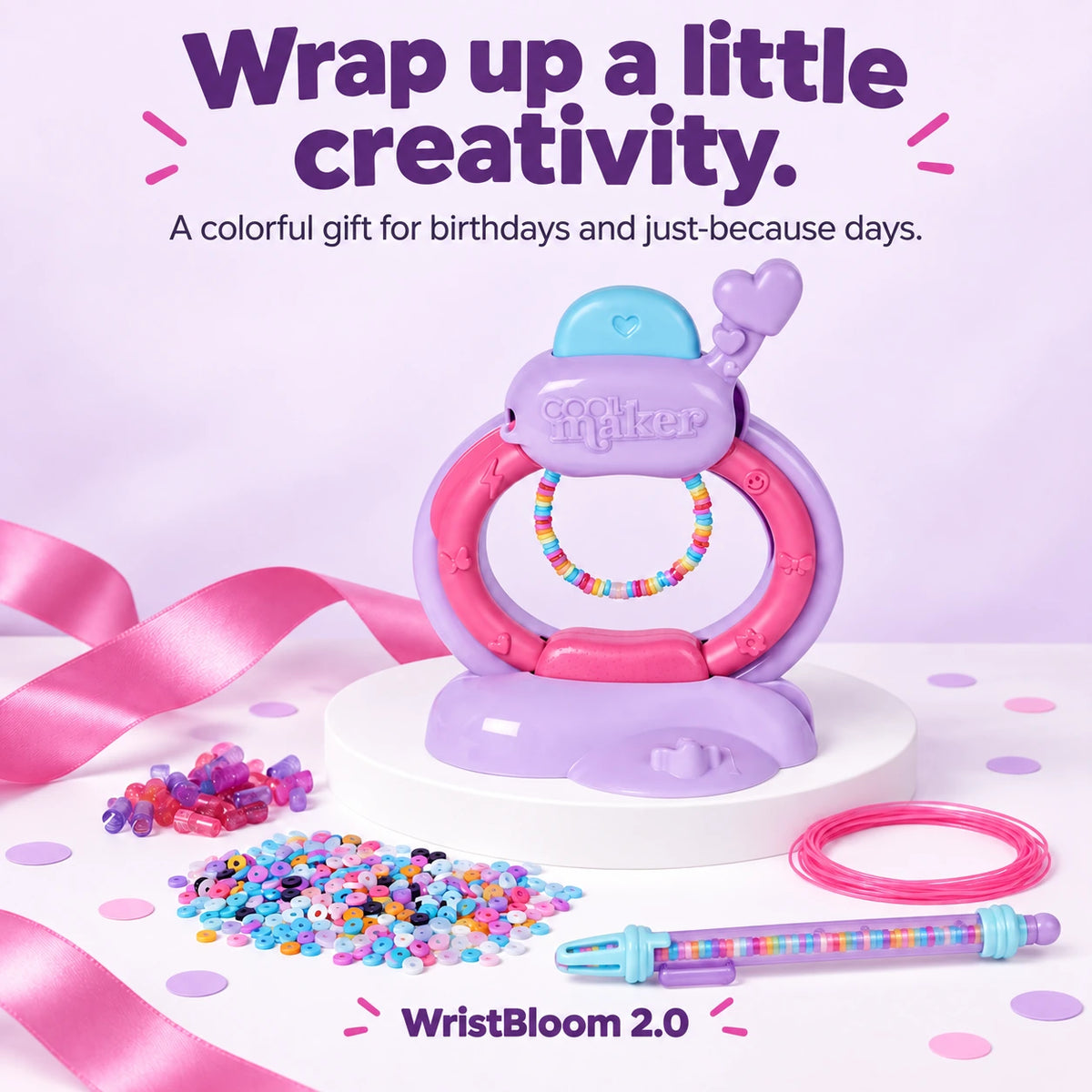 Bracelet-making studio and accessories styled with a pink gift ribbon.