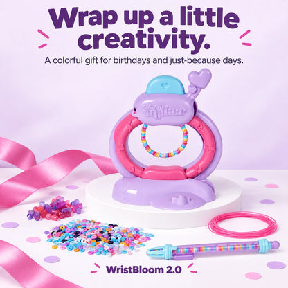 Bracelet-making studio and accessories styled with a pink gift ribbon.